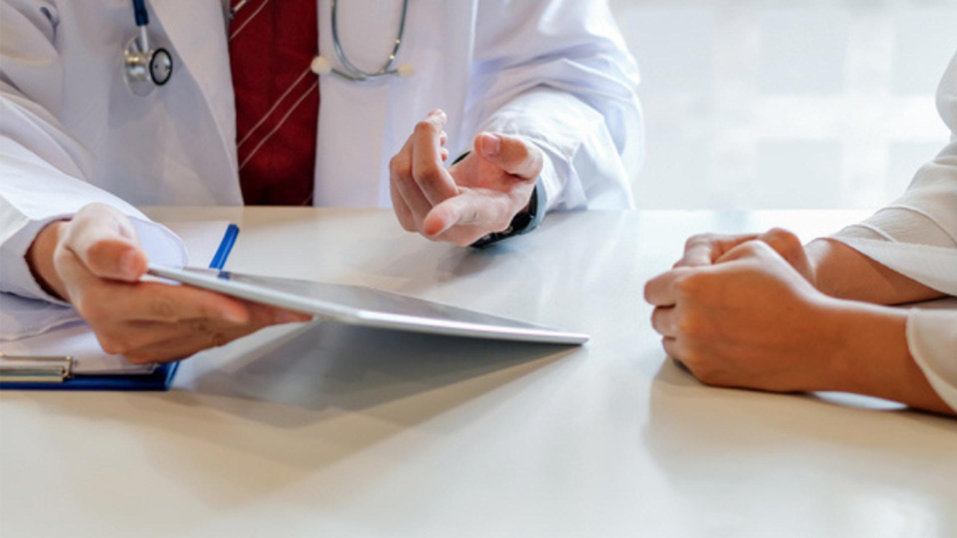 A doctor explaining their policy to a patient.